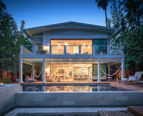 Touch Interiors dusk exterior shot with pool and hammocks
