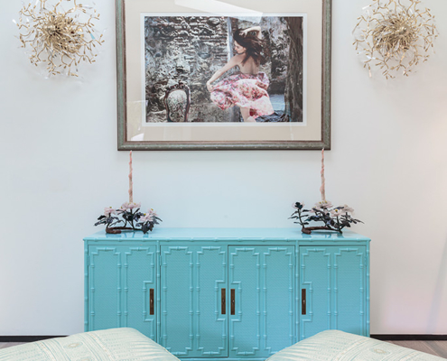 Touch Interiors turquoise sideboard with artwork and green rug
