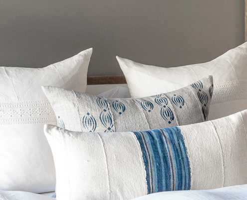 Blue and white pillows with lace bedding