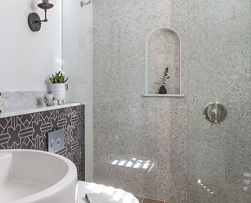 Small spaces bathroom remodel with tumbled stone tiled mosaic wall