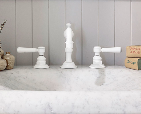 Carrara marble vanity with white faucet