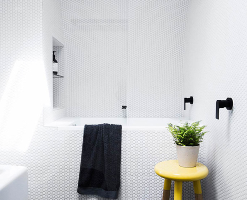 Bathroom with white penny round tiles