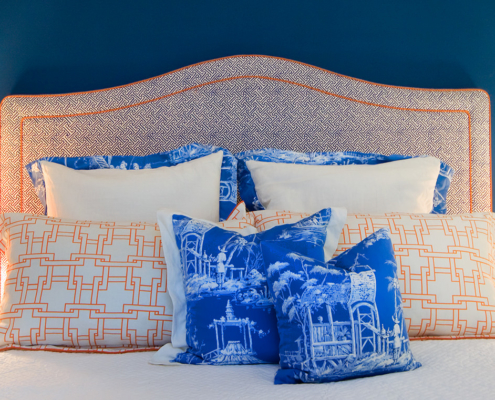 Touch Interiors custom headboard with blue and orange decor with Chinoiserie fabric