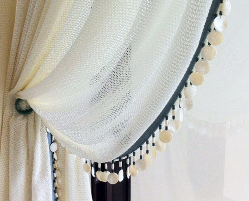 Touch Interiors detail of white mesh curtains with shell trim