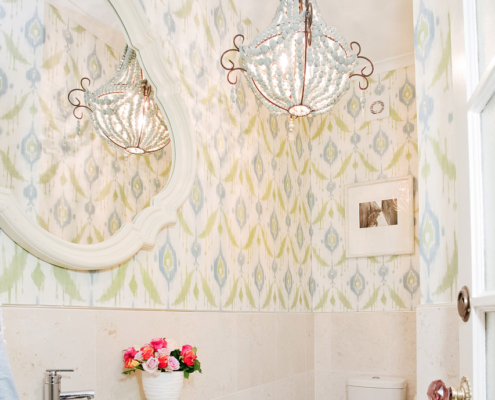 Thiabut ikat wallpaper in green and blue with handmade beaded chandelier